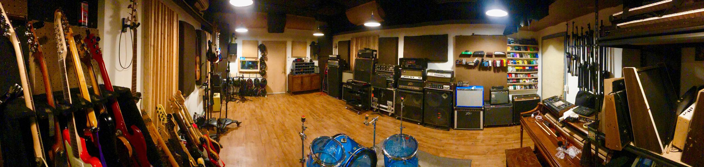 Live room at Cold War Studios — guitars, amps, drums, and pedals